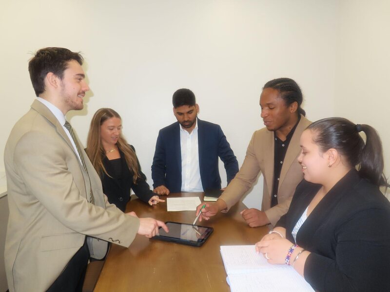 TriMkt team members reviewing campaign results around a table
